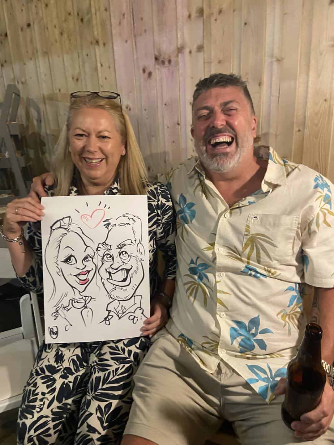 Laughing Couple holding caricature